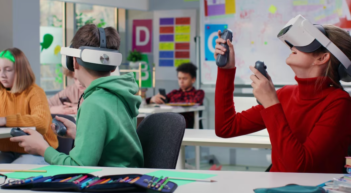 Teenage students with virtual reality glasses during a computer science class